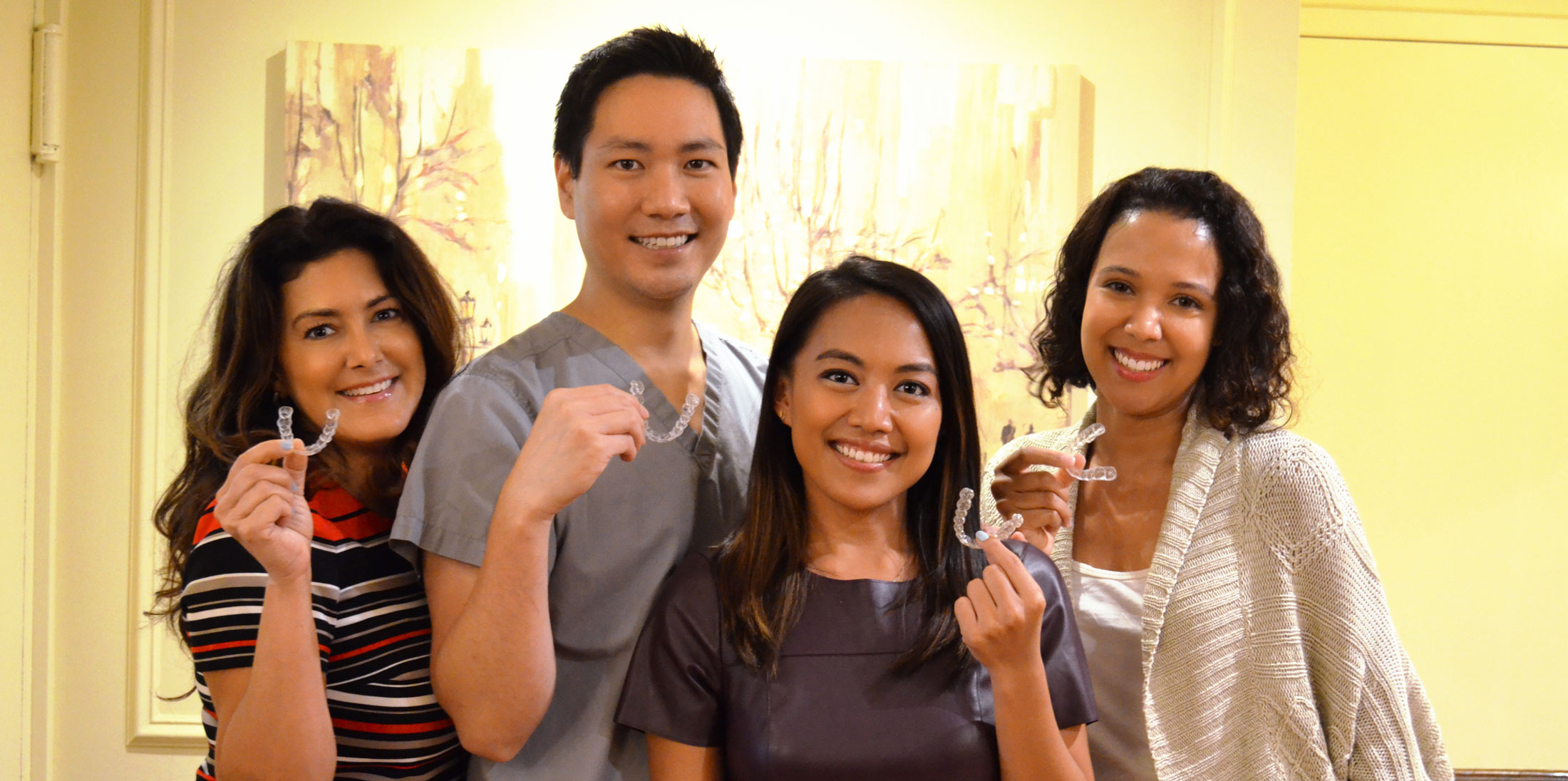 209 NYC Dental Office staff smiling while getting Invisalign Treatment in New York City Dentist Office