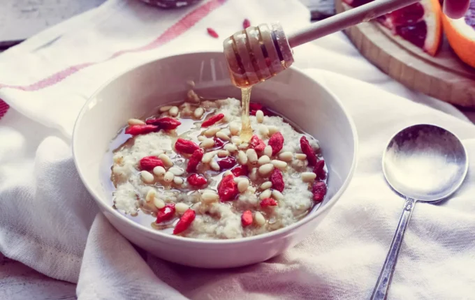 A bowl of oatmeal with nuts, which is a blend of canker sore-friendly foods
