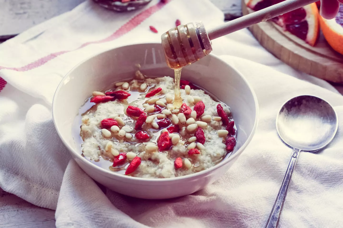 A bowl of oatmeal with nuts, which is a blend of canker sore-friendly foods