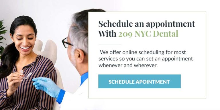 A patient holding an Invisalign aligner