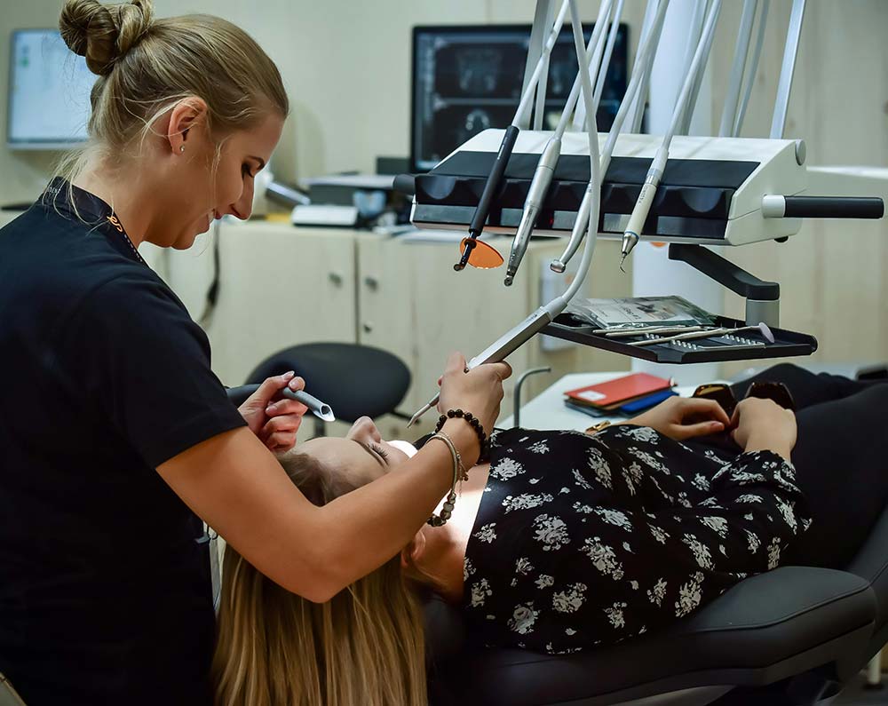 A dentist who provides oral cancer screenings examines a patient