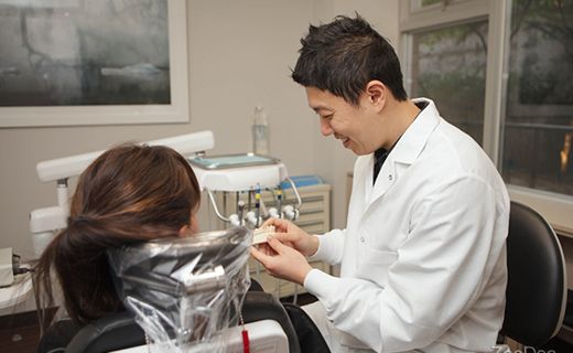 A dentist discussing a gingivectomy procedure with a patient