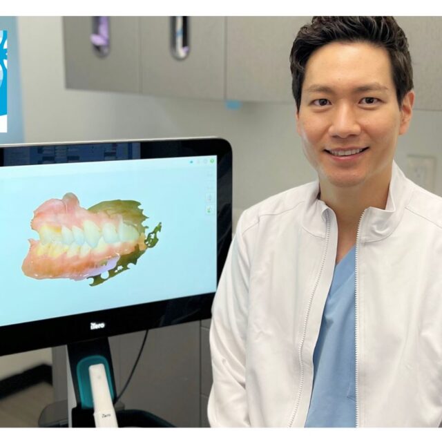 Dr. Sang (Benjamin) Ahn - Invisalign Blue Dimond Provider sitting next to iTero in his midtown Manhattan office